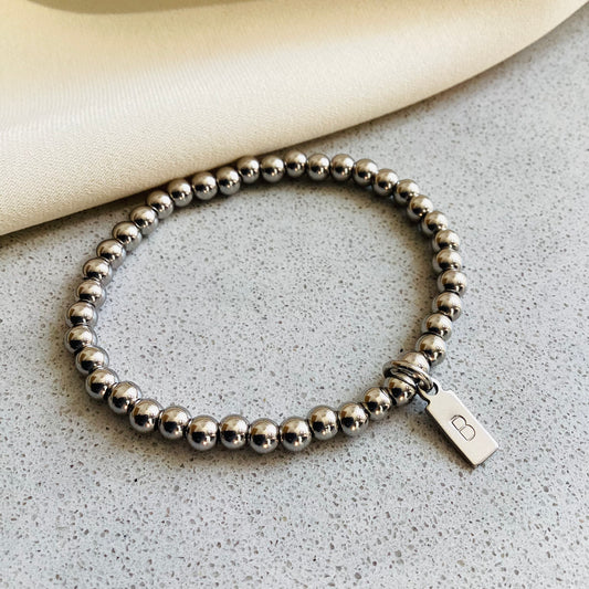 bracelet initiale perles rondes acier inoxydable argenté